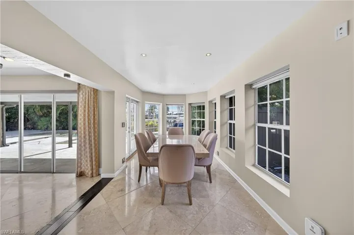 This bright interior space features recessed lighting and large windows, providing ample natural light