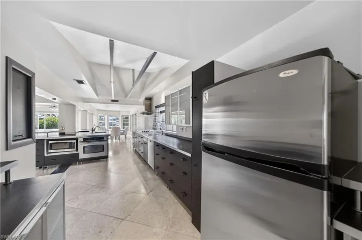 The kitchen features stainless steel appliances, a range oven, and a built-in microwave