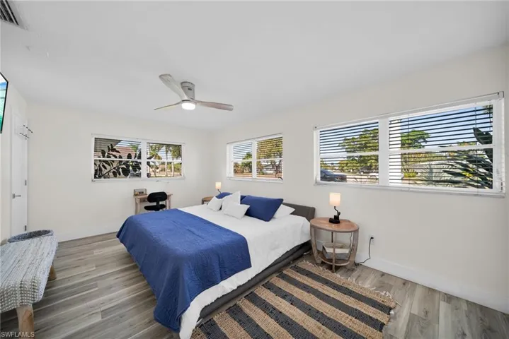 Bedroom with wood finished floors and a ceiling fan