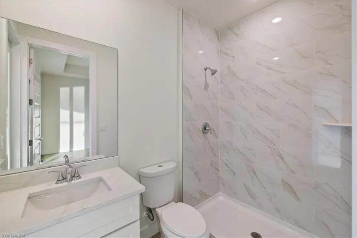 Bathroom featuring a stall shower and vanity