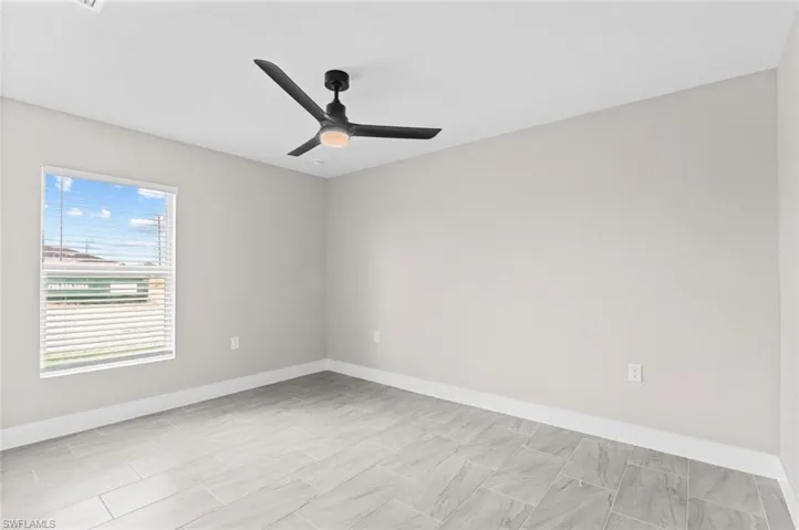 Spare room featuring baseboards and a ceiling fan