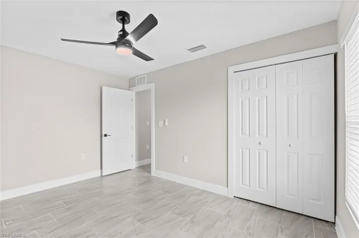 Unfurnished bedroom with a closet and a ceiling fan