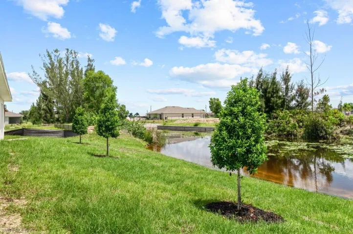 View of grassy yard with a water view