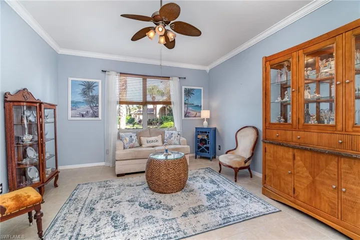 Sitting room with ornamental molding, baseboards, and light tile patterned floors
