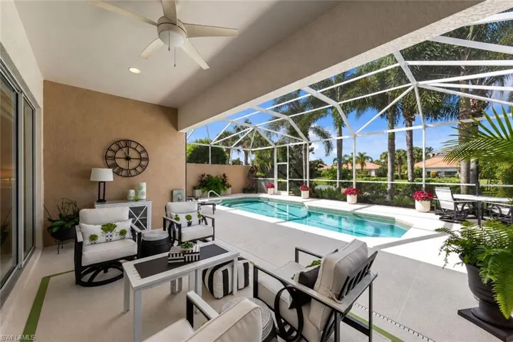 Covered lanai featuring a ceiling fan, recessed lighting, and a screened-in swimming pool enclosure
