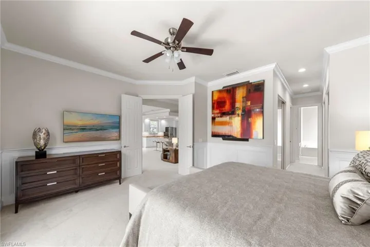 Room featuring crown molding, wainscoting, recessed lighting, and a ceiling fan with integrated light fixture