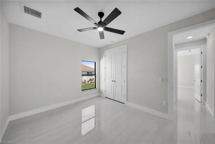 Unfurnished bedroom featuring a ceiling fan and a closet