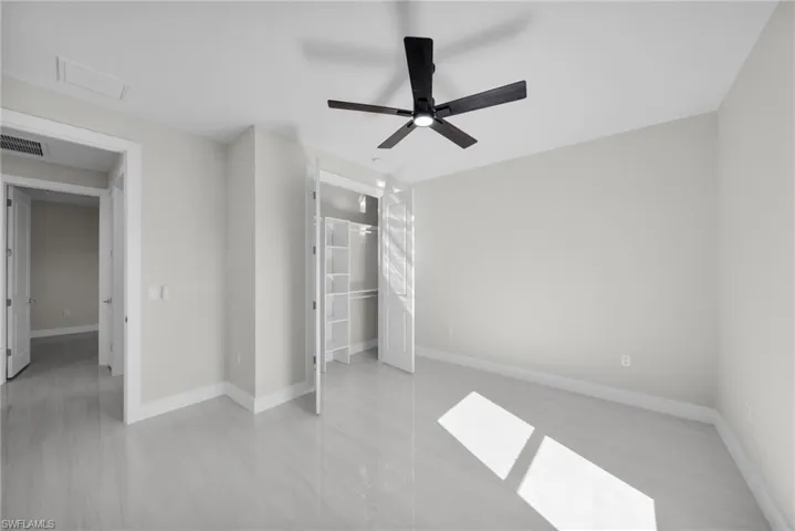 Unfurnished bedroom with baseboards and ceiling fan