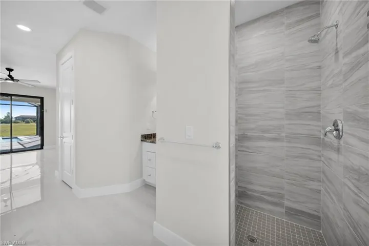 Full bath with a stall shower, vanity, recessed lighting, and a ceiling fan