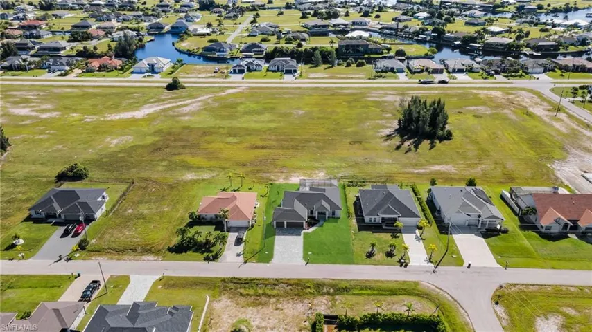 Aerial perspective of suburban area with a nearby body of water
