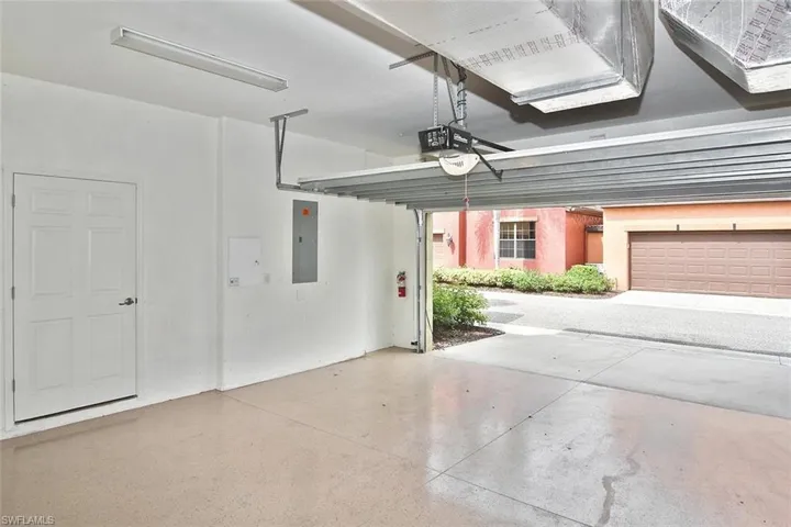 ...the roomy 2-car garage with epoxied flooring.  The door on the left opens into...