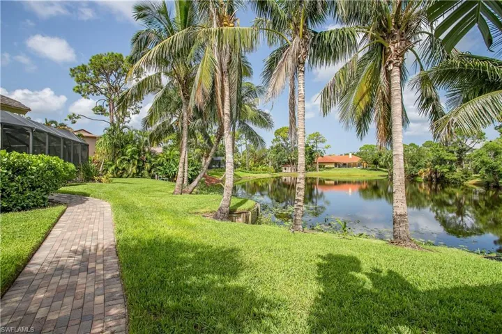 Paver sidewalk between structures and a water view