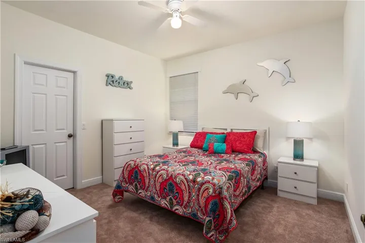 Carpeted bedroom with ceiling fan