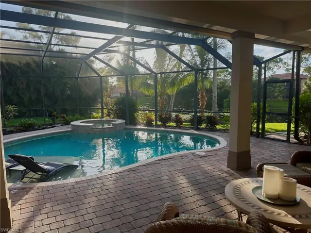 View of pool featuring an in ground hot tub, a patio, and screen enclosure