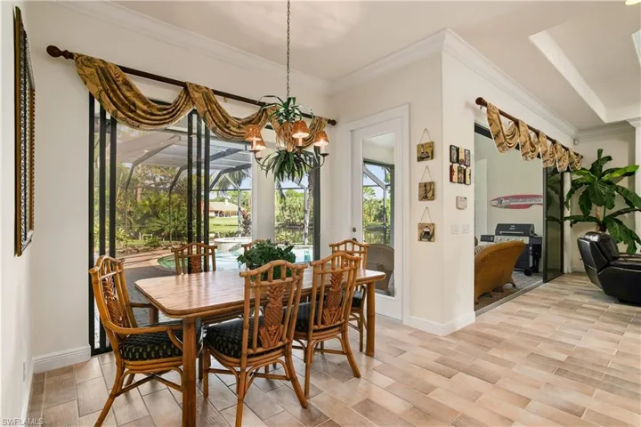 Dining room with a chandelier and crown molding