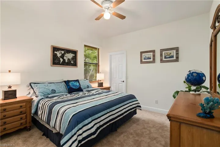 Carpeted bedroom with ceiling fan