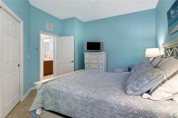 Carpeted bedroom featuring a closet