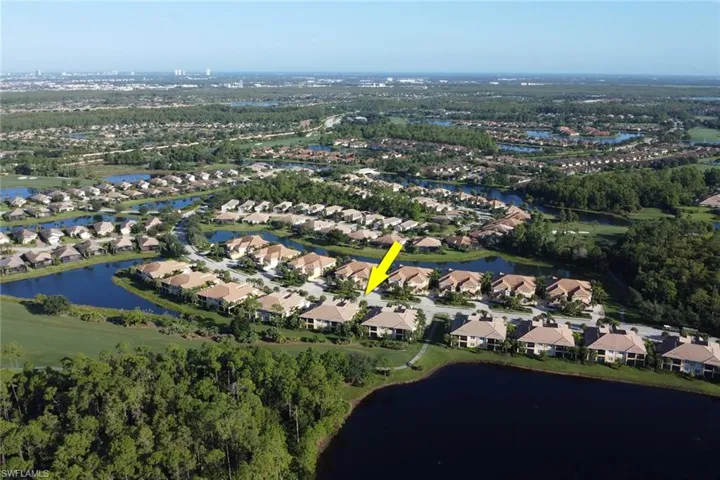 Birds eye view of property with a water view