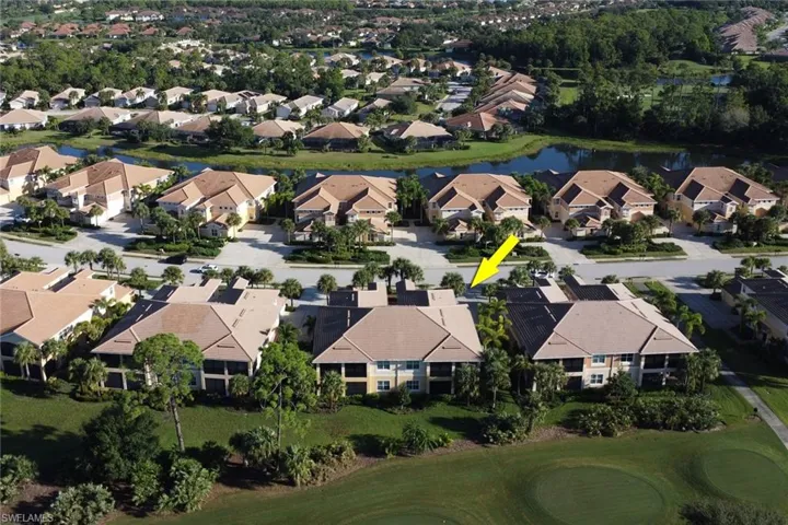 Birds eye view of property with a water view