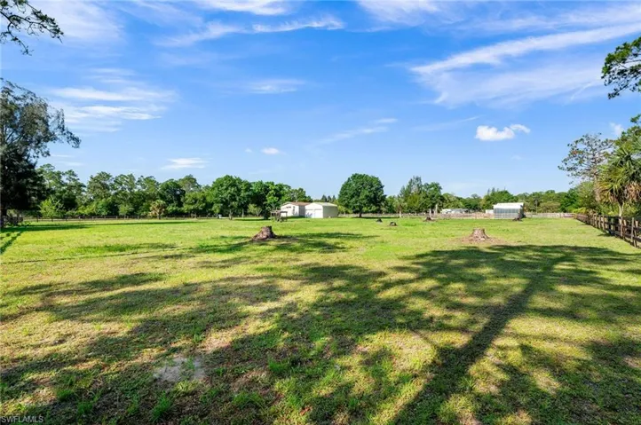 View of yard featuring a rural view and a storage unit