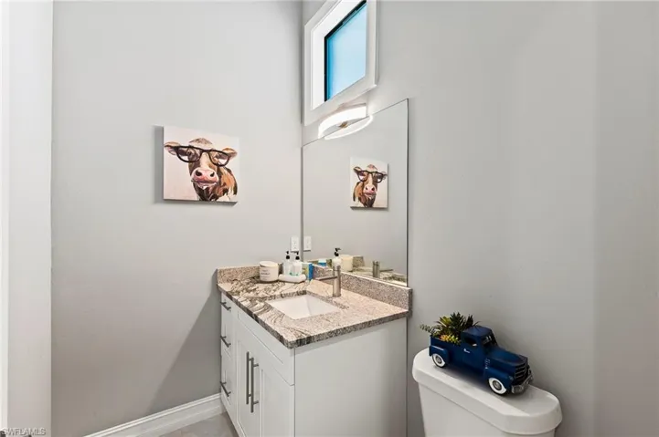 Bathroom featuring vanity and toilet