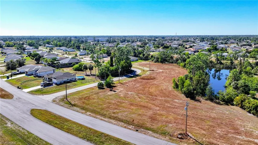 View of property location with nearby suburban area and a nearby body of water