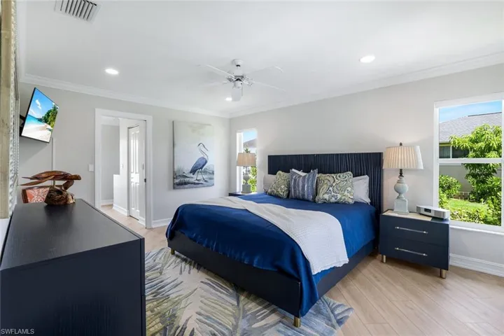 Bedroom featuring light wood-type flooring, ceiling fan, recessed lighting, and ornamental molding