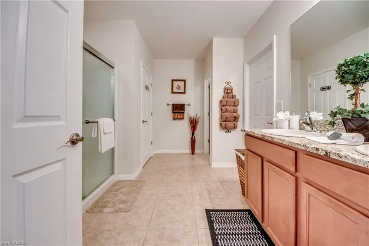 primary bathroom with a nice walk in closet and linen closet