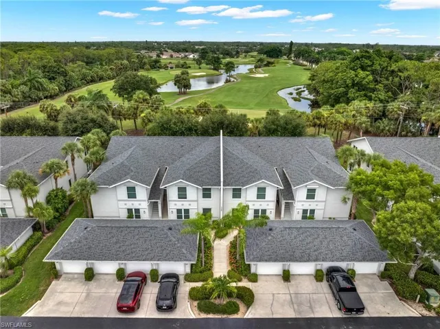 Aerial perspective highlighting a multi-unit property with a golf course backdrop