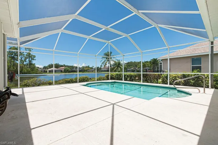 View of swimming pool with a lanai and a patio area