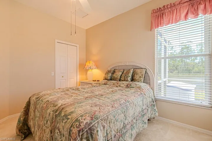 Bedroom #2 with carpet, a closet, ceiling fan, and lofted ceiling