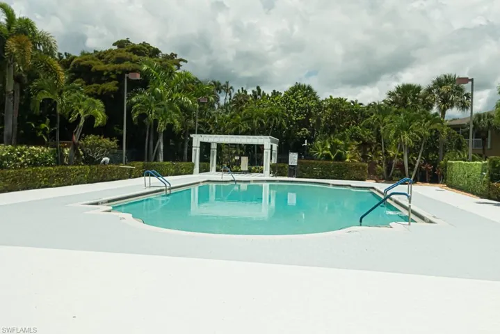 View of swimming pool with a pergola and a patio area