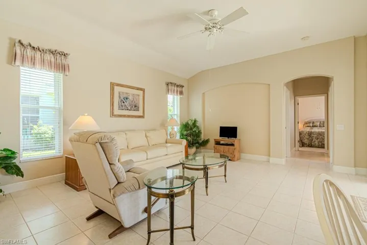 Tiled living room featuring ceiling fan