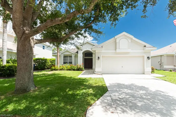 Ranch-style house with a garage and a front yard