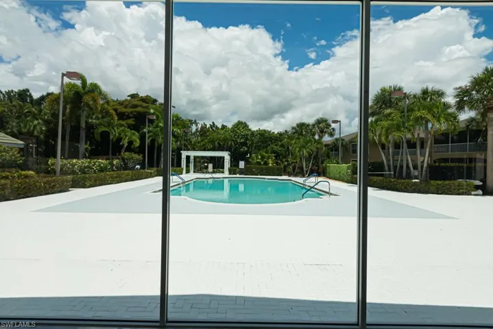 View of community pool freshly painted.  Lounge chairs are now replaced.