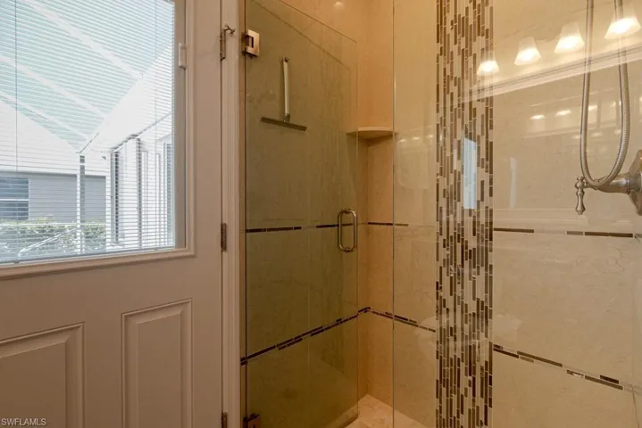 Guest Bathroom featuring an enclosed shower with access to pool area.
