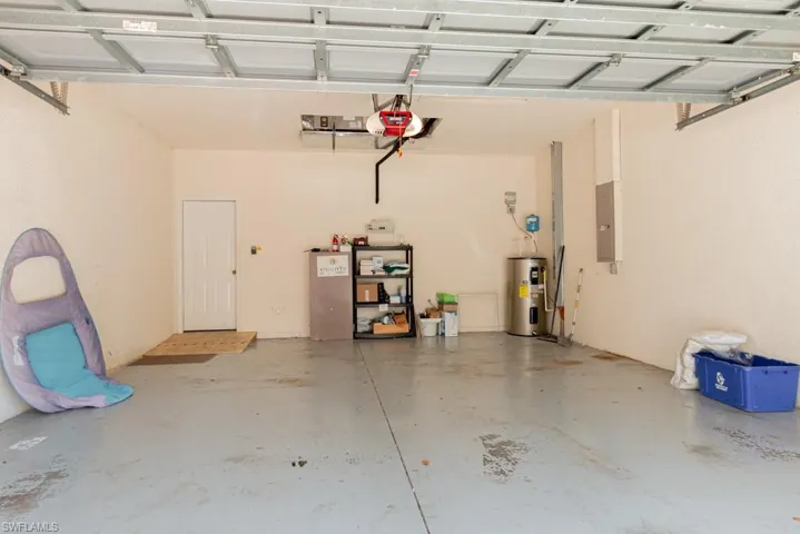 Spacious 2 car garage with a garage door opener and water heater