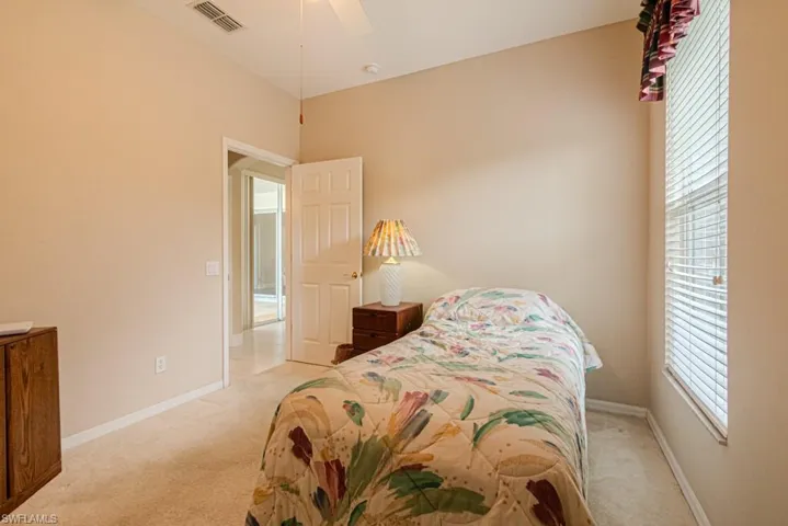 Bedroom featuring light carpet and ceiling fan