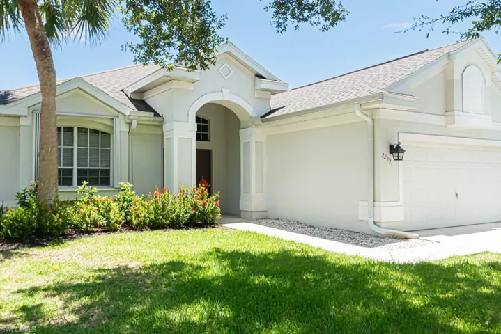 Single story home featuring a garage and a front yard