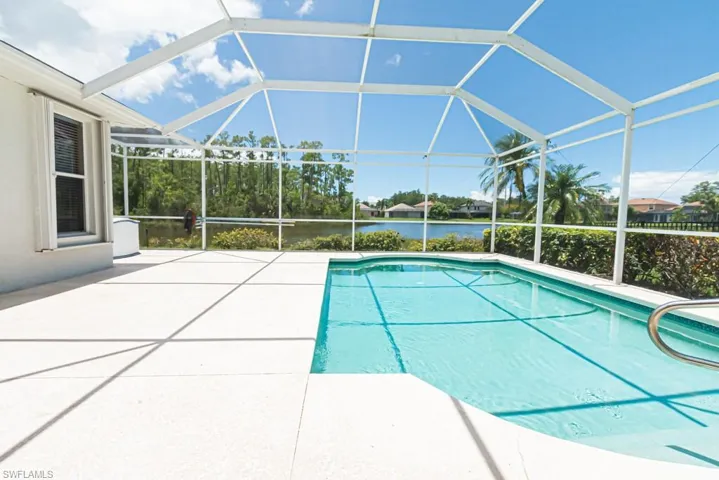 View of swimming pool with a lanai and a patio area