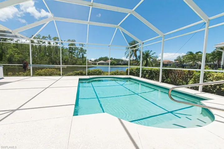 View of swimming pool featuring a patio and a lanai