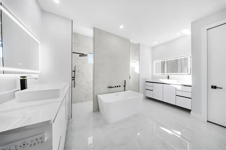 Master En-Suite with his & her vanities, pass-through shower.