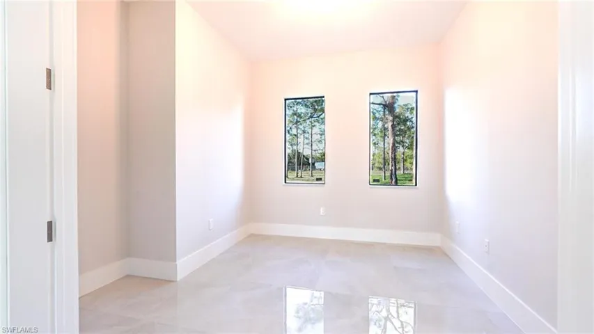 Unfurnished room with baseboards