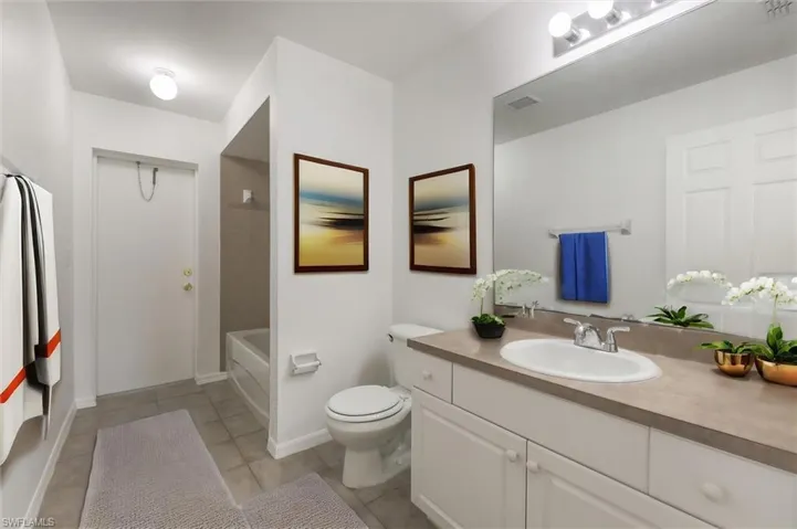 Full bathroom with tile patterned flooring, toilet, shower / bathing tub combination, and vanity