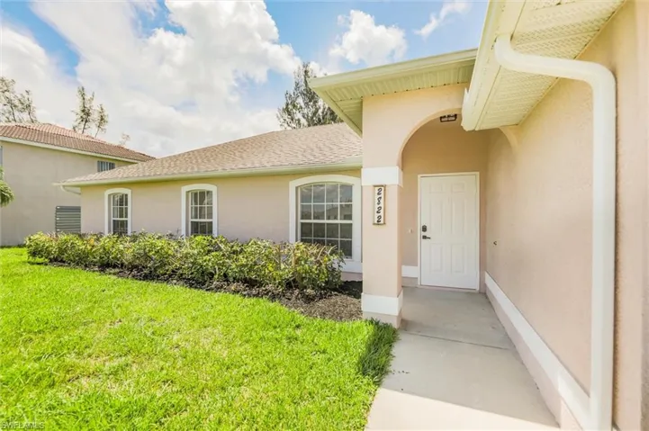 Property entrance with a lawn