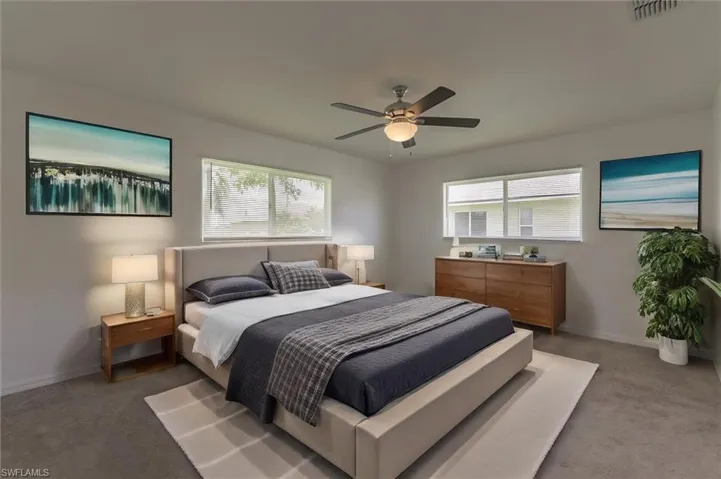 Carpeted bedroom with ceiling fan