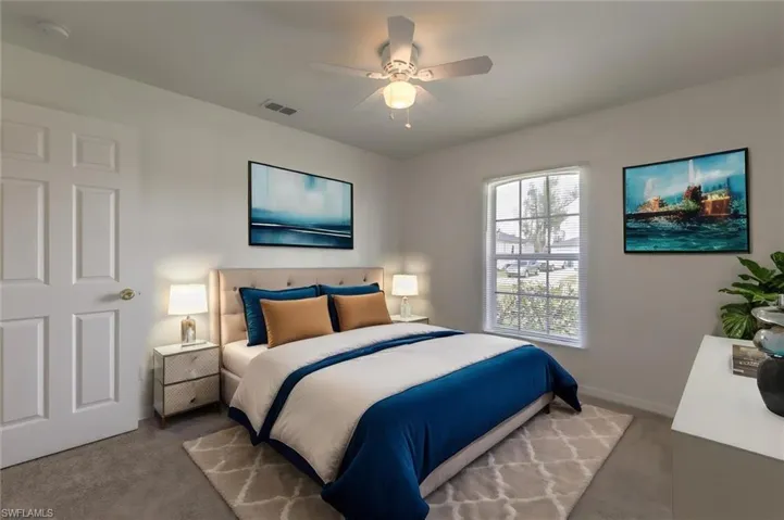 Bedroom with ceiling fan and carpet flooring