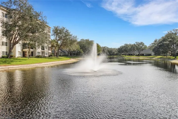 View of property's community lake with water feature