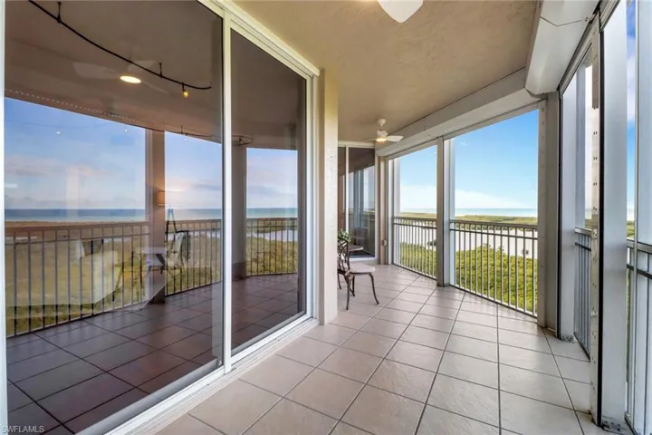View from the second bedroom accessing the screened in lanai with new ceiling fans, electric hurricane shutters and direct western views of the gulf.