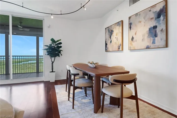 Dining area with wood finished floors, track lighting, baseboards, and a ceiling fan
